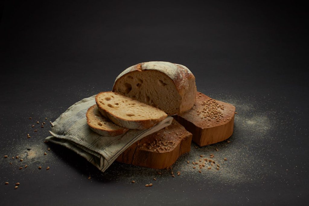 Sliced sourdough bread on a rustic surface, showcasing homemade culinary artistry.